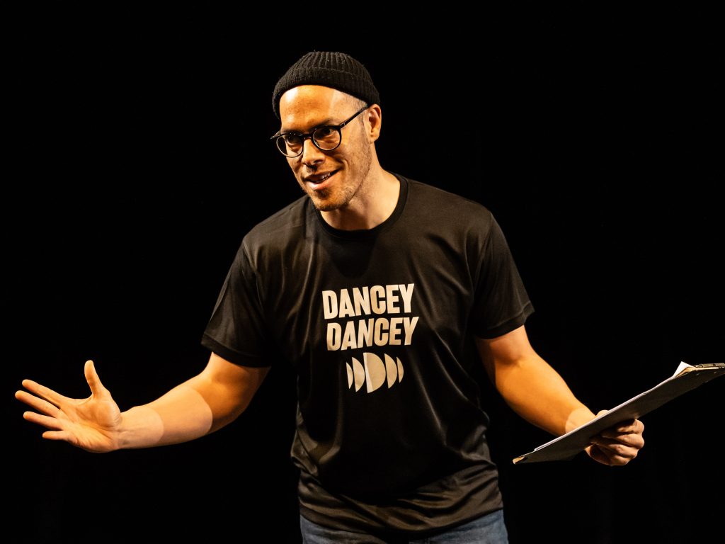 Tony Mills at Scratch Night 2024. Image credit Sally Jubb. Dance Base Artistic Director Tony Mills, onstage welcoming the audience to Scratch Night.