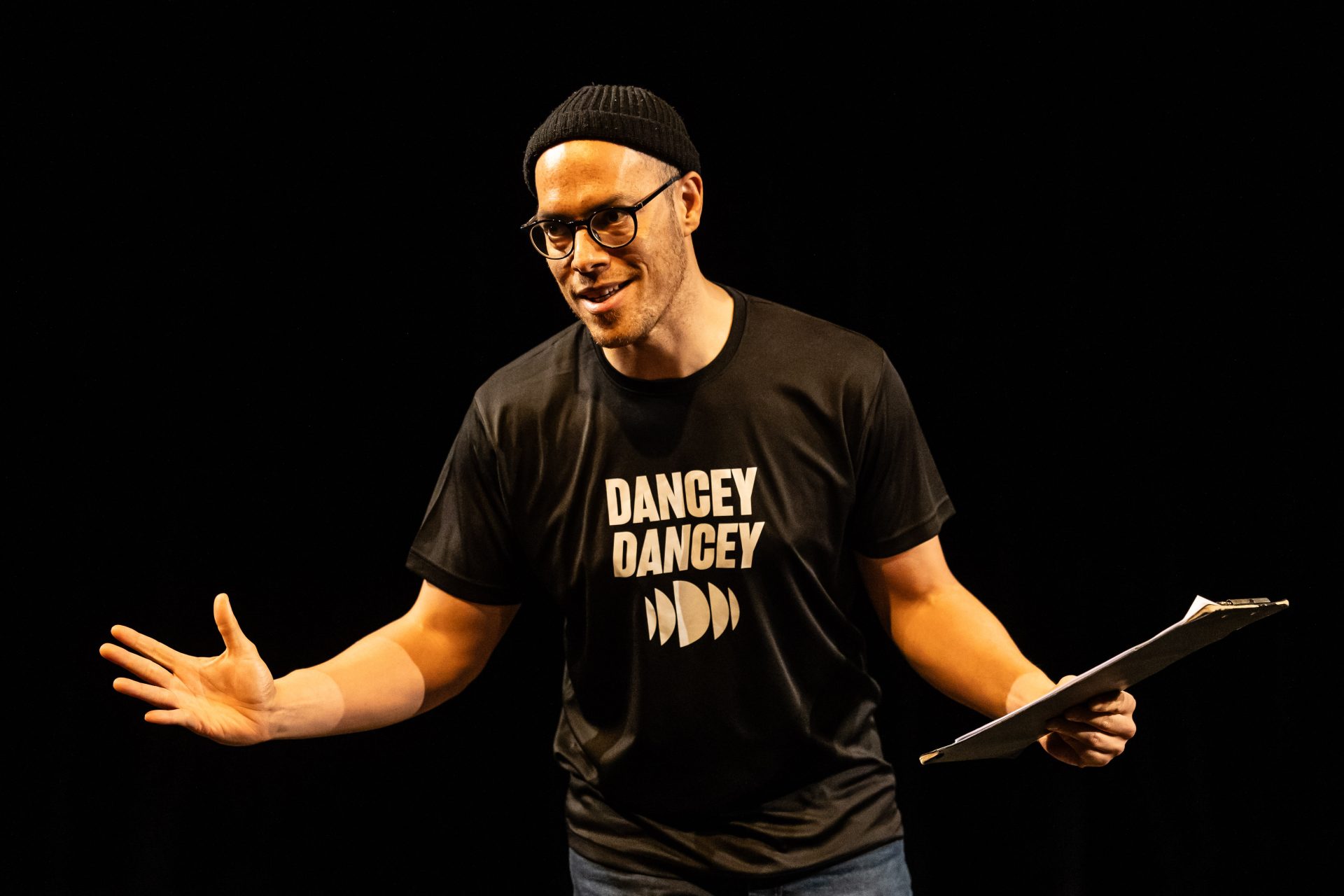 Dance Base Artistic Director Tony Mills, onstage welcoming the audience to Scratch Night.