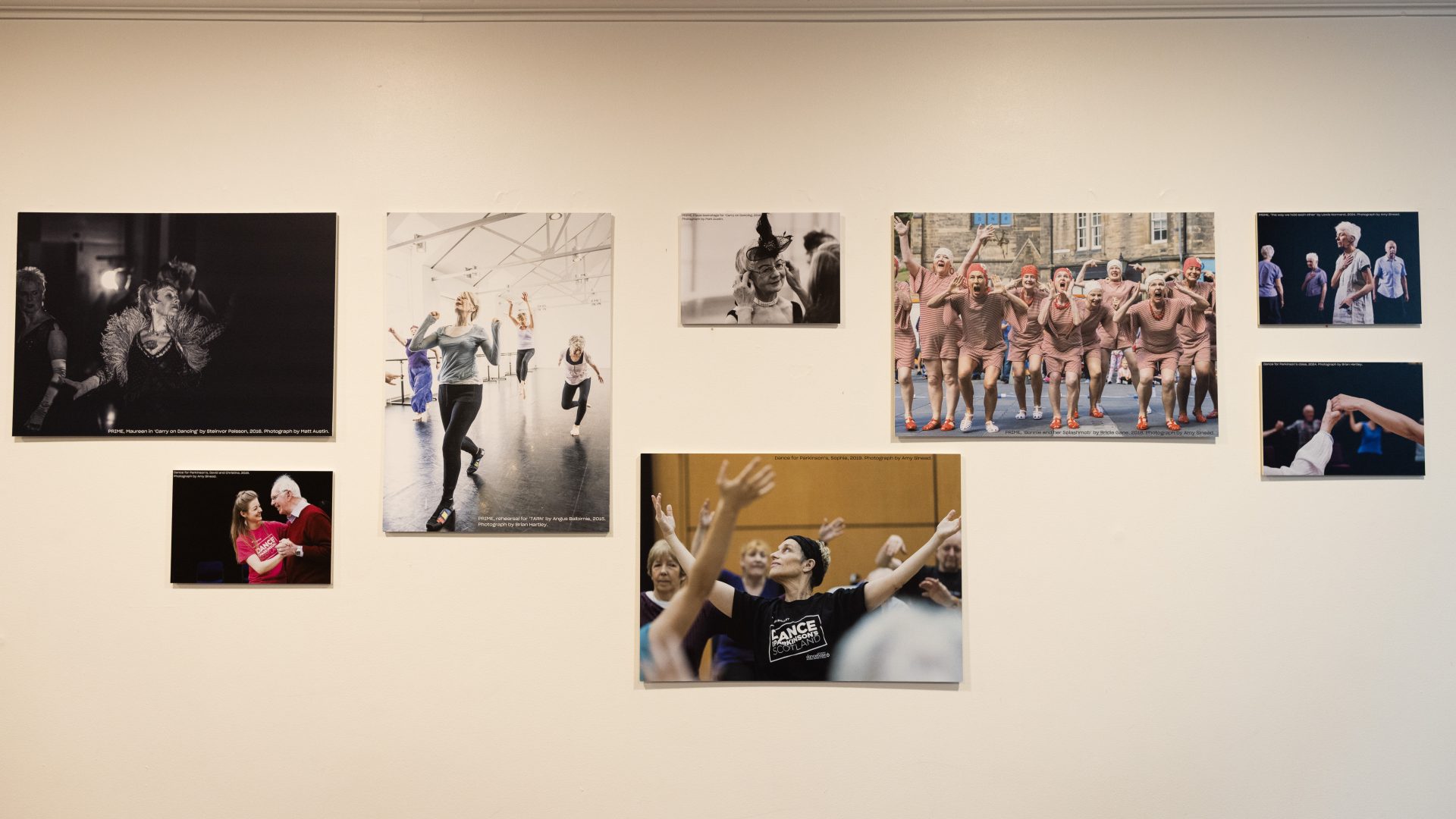 Dancing On Exhibition, Dance Base 2024-25. Image credit Stuart Armitt A front view of the exhibition hanging in Dance Base's upper foyer, showing eight of the images displayed.