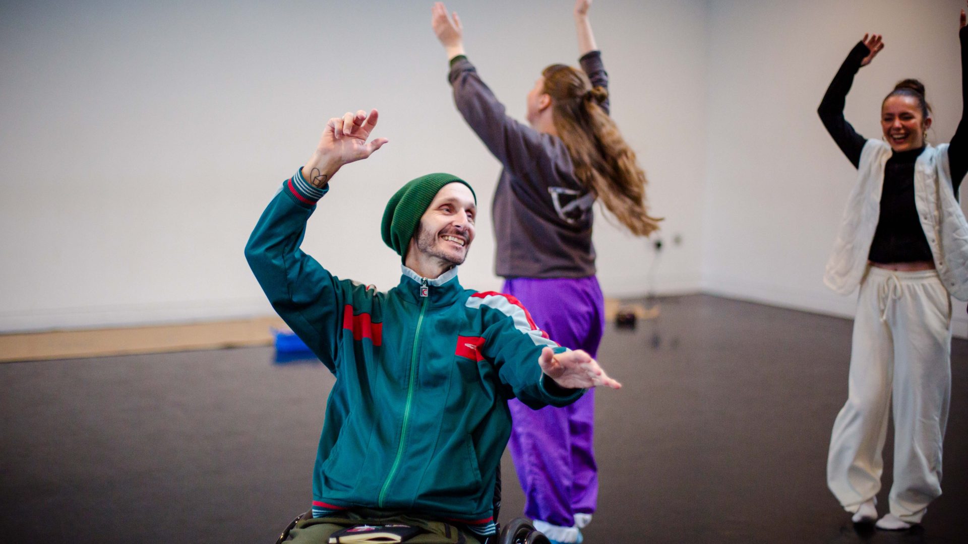 DEBS autumn residency 2025. Image credit: Paul Andrews Two young dancers kneel on the floor with their arms over their heads.